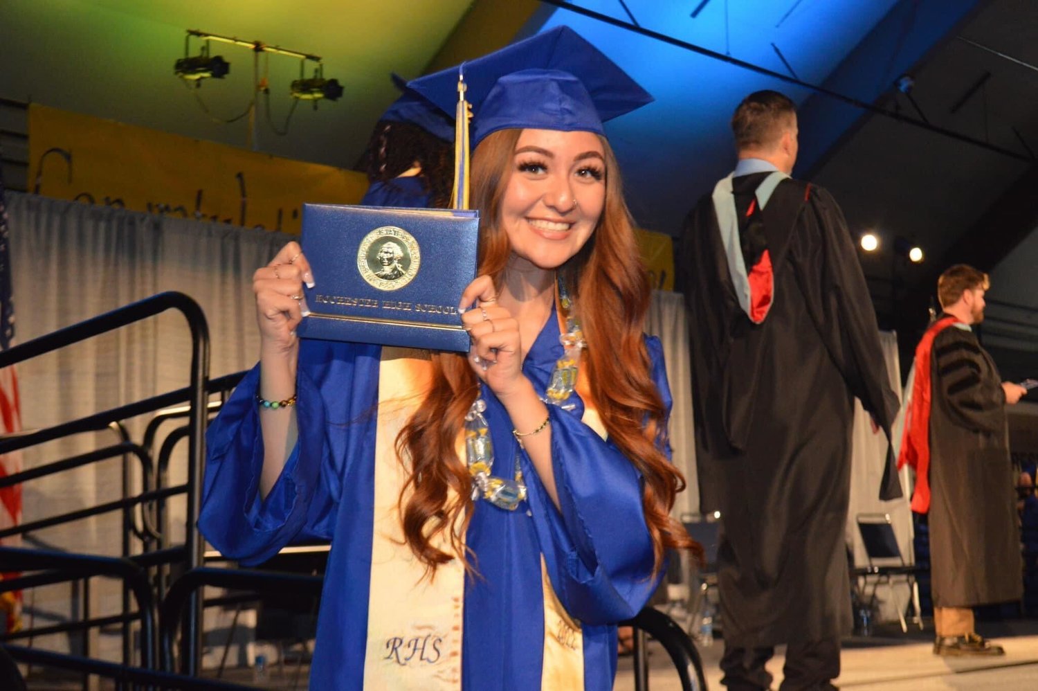 Nadia Martinez smiles with her diploma during a graduation ceremony in the Marcus Pavilion at St. Martin’s University Sunday in Lacey.